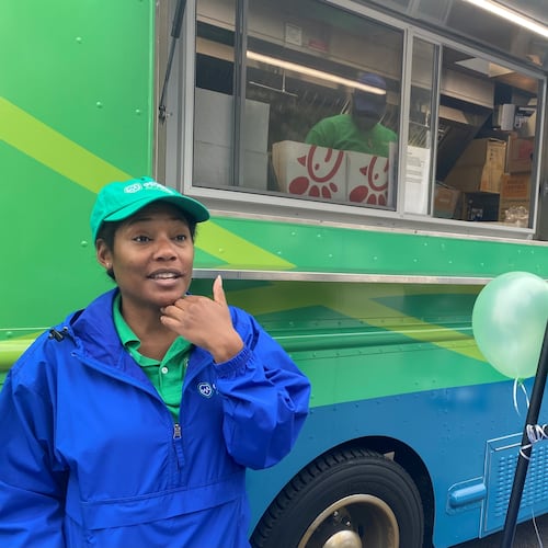 GeorgiaAccess.gov outreach workers like Sheena Wiley travel the state handing out promotional materials for people who might be eligible for health insurance. The truck behind Wiley serves tea and coffee. Georgia Access is the state-based exchange marketplace for the Affordable Care Act in Georgia. (Ariel Hart/AJC 2024)