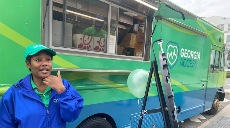 GeorgiaAccess.gov outreach workers like Sheena Wiley travel the state handing out promotional materials for people who might be eligible for health insurance. The truck behind Wiley serves tea and coffee. Georgia Access is the state-based exchange marketplace for the Affordable Care Act in Georgia. (Ariel Hart/AJC 2024)
