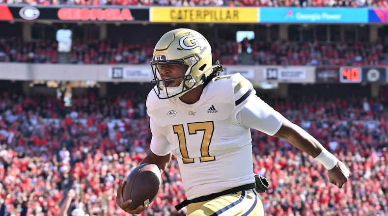 Georgia Tech quarterback Taisun Phommachanh scores a touchdown during the first half against Georgia on Saturday at Sanford Stadium. (Hyosub Shin/Atlanta Journal-Constitution/TNS)