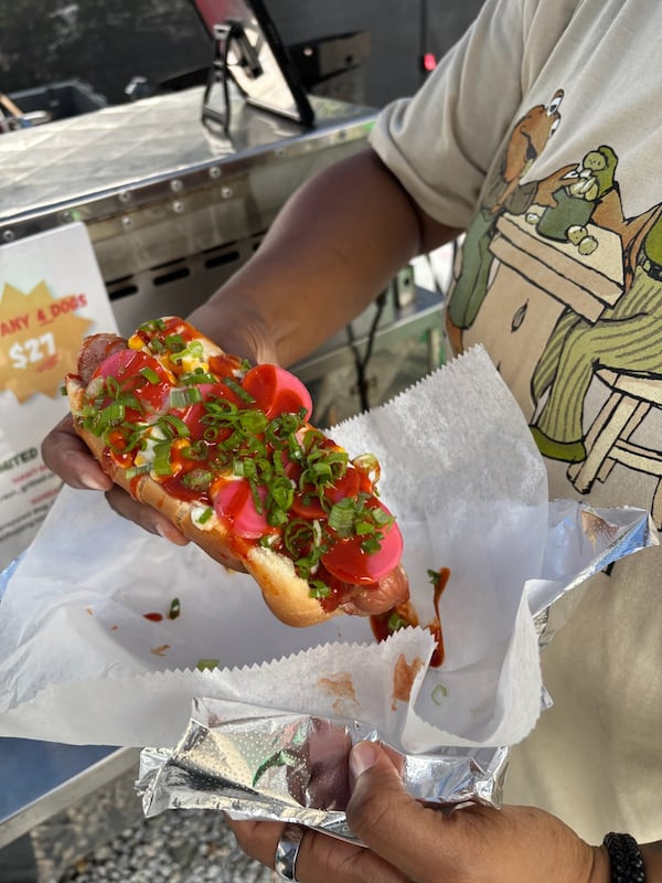 Loaded hot dog topped with chopped tomatoes, peppers and herbs from Daddy’s Dogs.