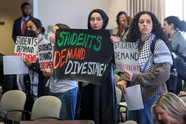 A group of students and alumni of institutions of University Systems of Georgia perform a silent sit-in during the USG Board of Regent’s meeting, Tuesday, Jan. 14, 2025, in Atlanta. The protest was organized by Georgia Tech Alumni for Palestine. (Jason Getz / AJC)