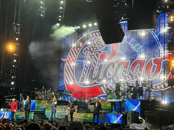 Chicago band members wave to the crowd at the end of their August 2024 concert at Ameris Bank Amphitheatre. (Rodney Ho/AJC)