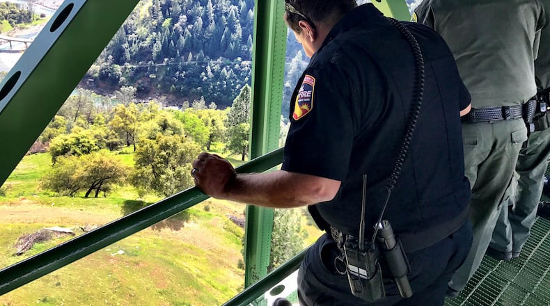 In this photo provided by the Placer County Sheriff's Office, sheriff's and other officials look where a woman fell 60 feet while trying to take a selfie on the 730-foot-tall Foresthill Bridge, Wednesday, April 5, 2017, near Auburn, Calif. (Placer County Sheriff's Office via AP)