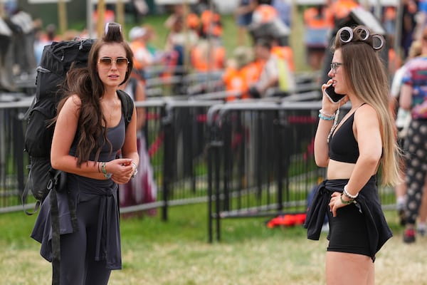 Festival goers arrive at the Glastonbury Festival in Worthy Farm, Somerset, England, Wednesday, June 25, 2025. (Scott A Garfitt/Invision/AP)