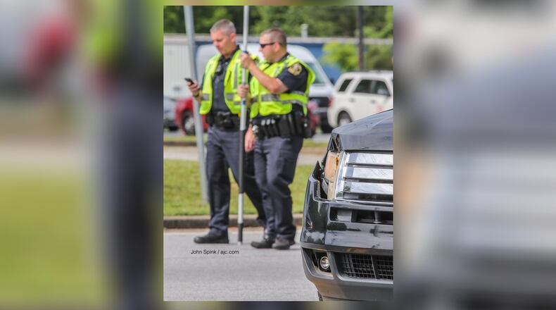 Authorities check out the scene and the damage to the vehicle.