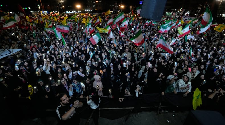 Demonstrators wave Iranian flags and flags of Lebanon's militant Hezbollah group during a pro-government gathering at Islamic Revolution Square in Tehran, Iran, Saturday, May 30, 2026. (AP Photo/Vahid Salemi)