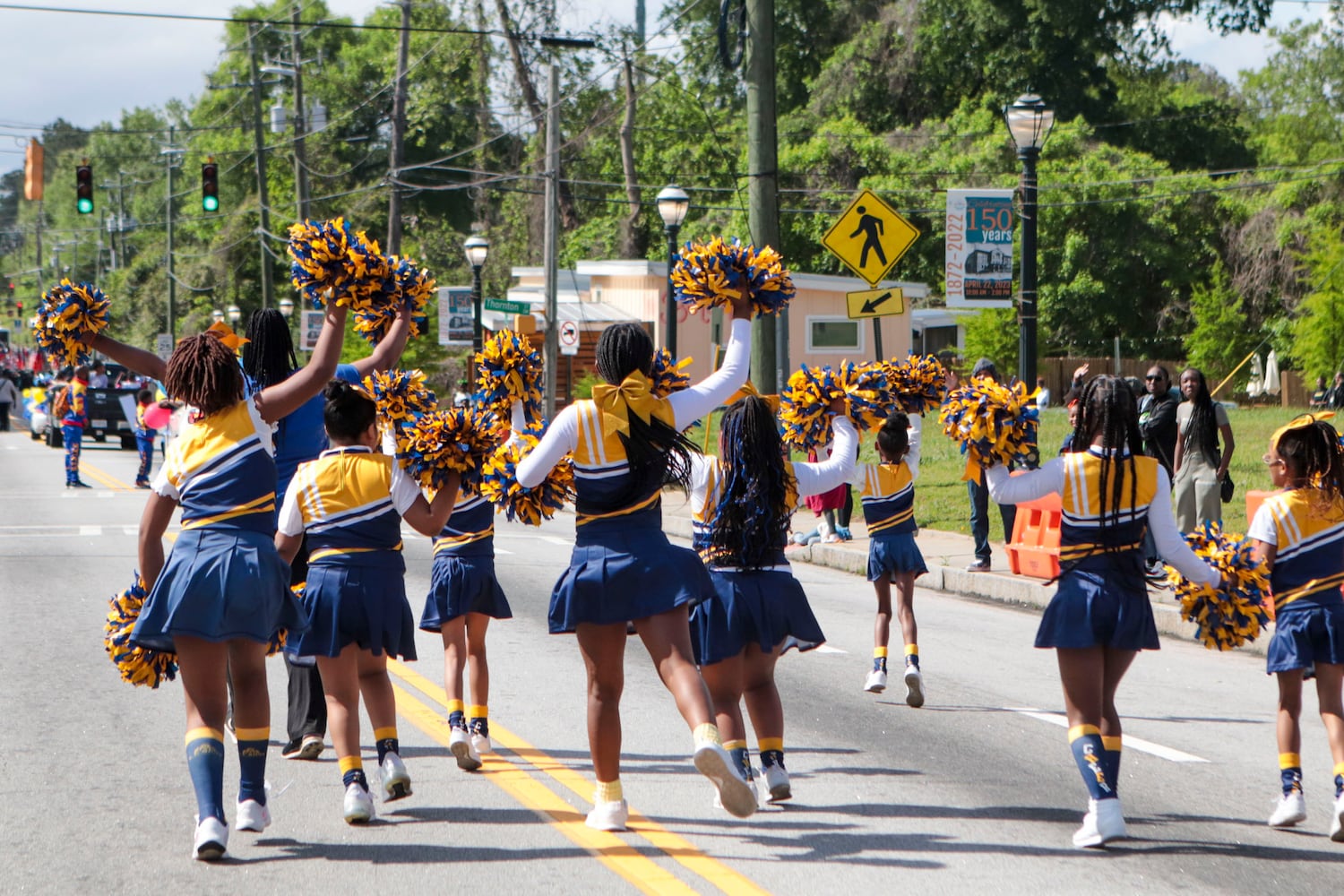 Cheerleaders cheer throughout the Atlanta Public School parade on Saturday, April 22, 2023. The parade celebrated the 150th anniversary of Atlanta Public Schools and featured students, teachers and other members of the APS community. CHRISTINA MATACOTTA FOR THE ATLANTA JOURNAL-CONSTITUTION