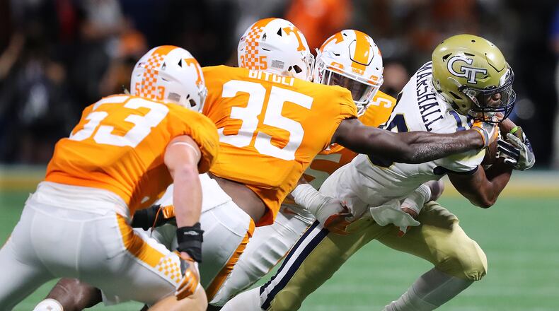 Georgia Tech quarterback TaQuon Marshall tries to run through three Tennessee defenders in the second quarter Monday night. (Curtis Compton/ccompton@ajc.com)
