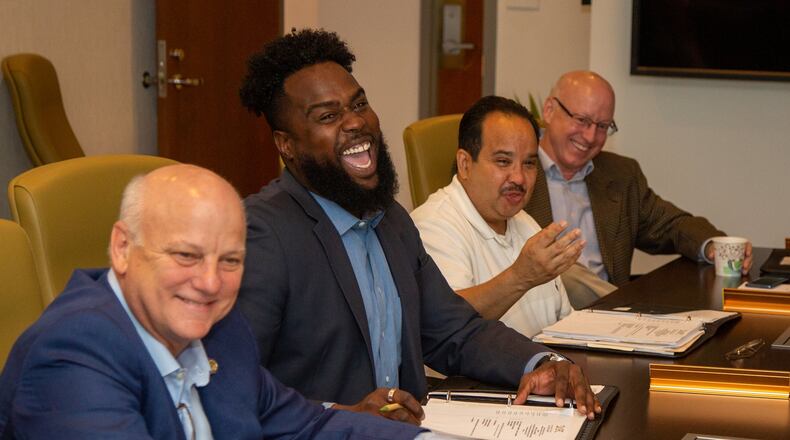Development Authority of Fulton County board members (left to right) Brandon Beach, Kyle Lamont, Michel Turpeau and Thomas Tidwell share a humorous moment during a meeting in August 2019 at the Fulton County Government Center in Atlanta. School leaders and the city’s development authority want Fulton County to stop handing out tax breaks to development projects located in Atlanta. (Photo by Phil Skinner)