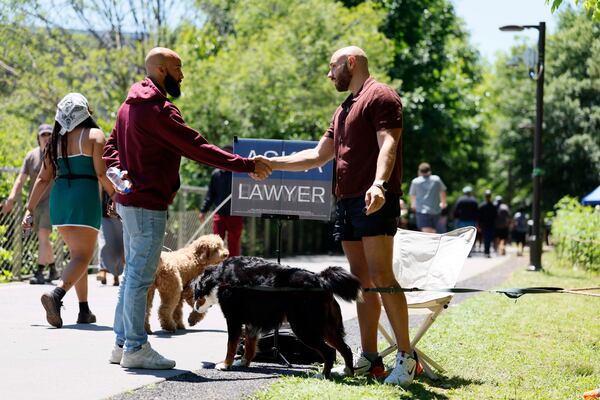 Edlin Veras (left), an assistant professor of sociology at Swarthmore College near Philadelphia, greets Atlanta attorney Cody Randall at the Beltline on Sunday, May 3, 2026. (Miguel Martinez/AJC)