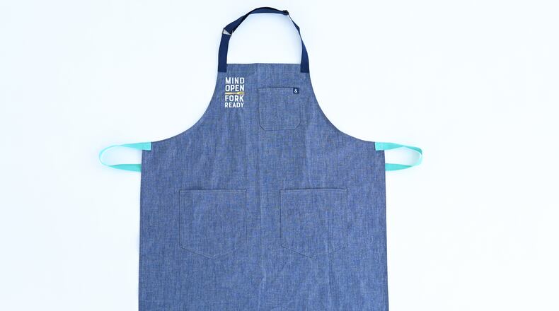 The gift of a Kalamata Kitchen apron also gives back to an organization dedicated to resolving child hungry challenges. /
Courtesy of Jen Brown