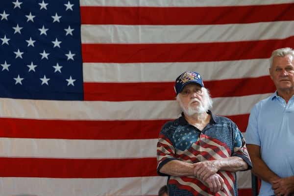 Larry Knapp stands in front of an American flag at Republican nominee for governor Rick Jackson’s rally at Meadows at Mossy Creek in Cleveland on Thursday. (Arvin Temkar/AJC)