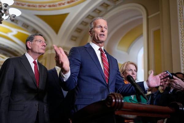 Senate Majority Leader John Thune (center) R-S.D., joined by colleagues, talks about tariffs to news reporters at the U.S. Capitol on Wednesday.