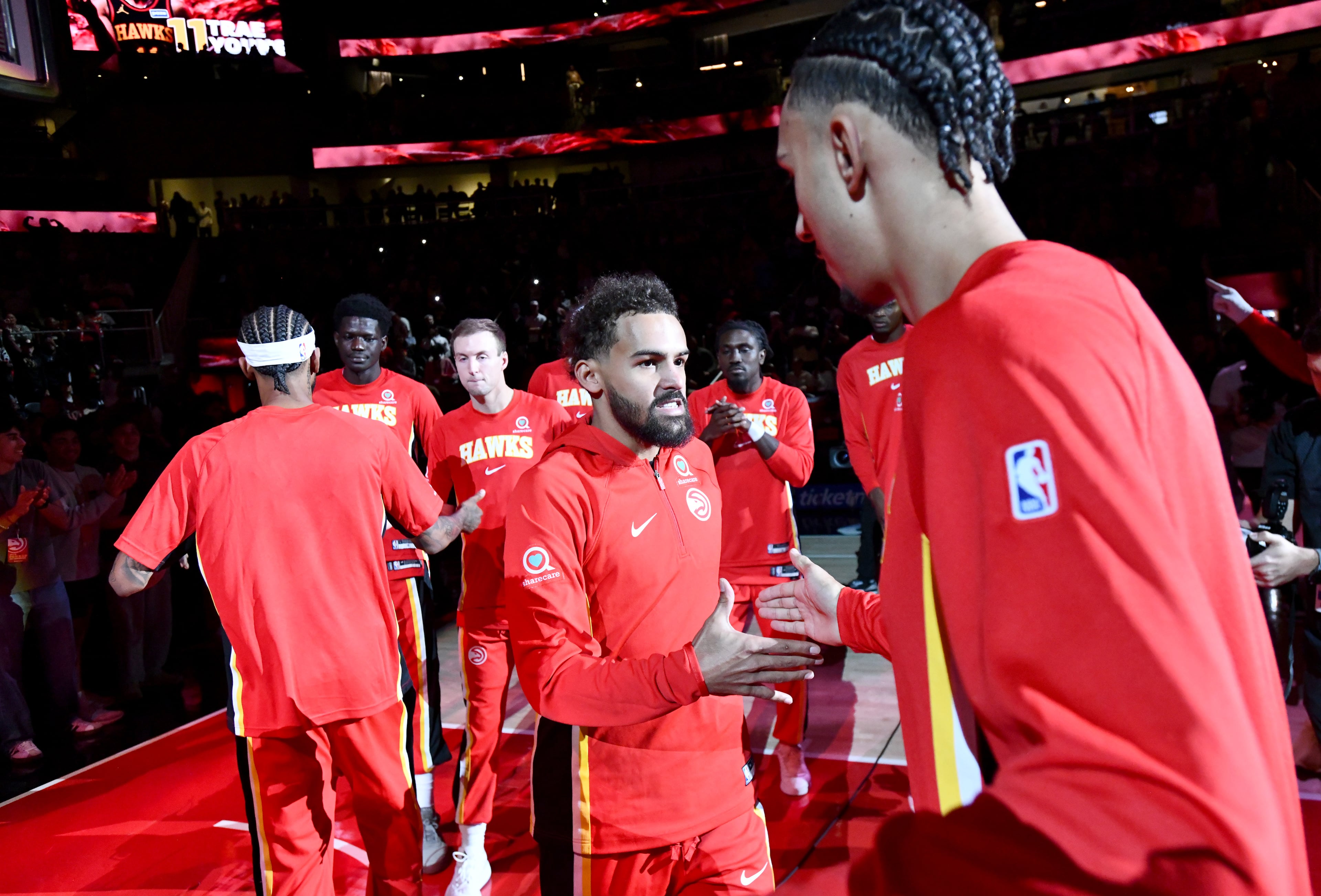 Atlanta Hawks guard Trae Young (11) cheers up with teamates prior to the Atlanta Hawks home opener against Toronto Raptors at State Farm Arena, Thursday, October 22, 2025, in Atlanta. (Hyosub Shin / AJC)