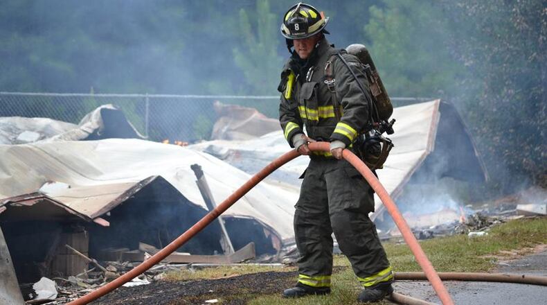 Cherokee County firefighters respond to a blaze possibly sparked by lightning. The county recently approved transferring fire hoses and other gear declared surplus to a volunteer department in Pickens County. TIM CAVENDER/CHEROKEE COUNTY FIRE & EMERGENCY SERVICES