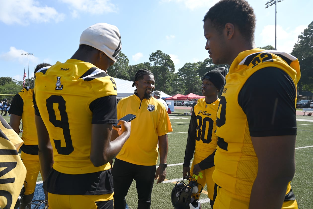 Lithonia football head coach Kevin Barnes (center) speaks to his players during the DeKalb County School District Athletics Media Day at Napoleon B. Cobb Stadium on Thursday, July 16, 2026, in Decatur. (Hyosub Shin/AJC)