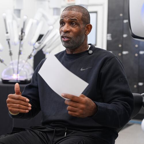 Colorado head football coach Deion Sanders talks after working the Da Vinci robotic surgical machine used to remove his cancerous bladder last year, during a demonstration of the device, Tuesday, June 23, 2026, in Boulder, Colo. (David Zalubowski/AP)