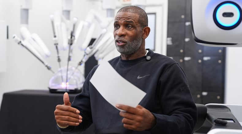 Colorado head football coach Deion Sanders talks after working the Da Vinci robotic surgical machine used to remove his cancerous bladder last year, during a demonstration of the device, Tuesday, June 23, 2026, in Boulder, Colo. (David Zalubowski/AP)