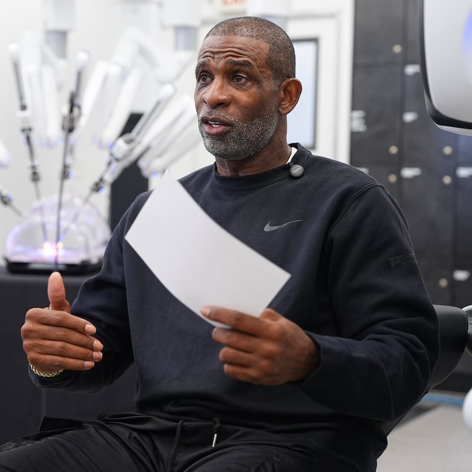 Colorado head football coach Deion Sanders talks after working the Da Vinci robotic surgical machine used to remove his cancerous bladder last year, during a demonstration of the device, Tuesday, June 23, 2026, in Boulder, Colo. (David Zalubowski/AP)
