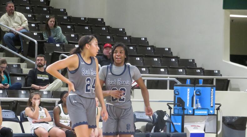 St. Francis Lady Knights Mia Moore (22) and Savannah Samuel (24) talk during a break in their Class A Private semifinal game against the Wesleyan Lady Wolves on Friday, Feb. 28, 2020 at Georgia College and State University'sCentennial Center in Milledgeville. (Adam Krohn for the AJC)