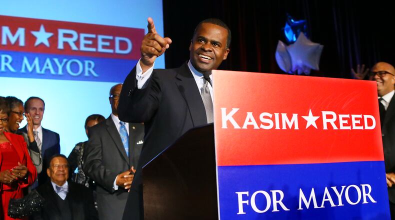 Atlanta Mayor Kasim Reed thanks supporters for four more years with ambassador Andy Young (seated) looking on while delivering his victory speech at his election night celebration on Nov. 5, 2013, in Atlanta.