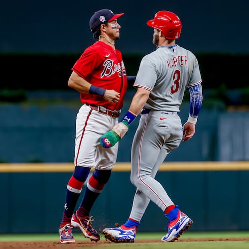 Philadelphia Phillies' Bryce Harper (right) is tagged out by Atlanta Braves shortstop Mauricio Dubón (left) during the ninth inning of a baseball game, Friday, Sept. 11, 2026, in Atlanta. (Erik S. Lesser/AP)