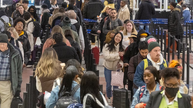 Early morning travelers make their way through the security line at Hartsfield-Jackson Atlanta International Airport Saturday, Dec. 24, 2022.   (Steve Schaefer/steve.schaefer@ajc.com)