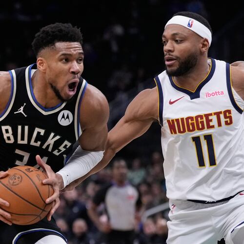 Milwaukee Bucks' Giannis Antetokounmpo tries to drive past Denver Nuggets' Bruce Brown during the second half of an NBA basketball game Friday, Jan. 23, 2026, in Milwaukee. (AP Photo/Morry Gash)