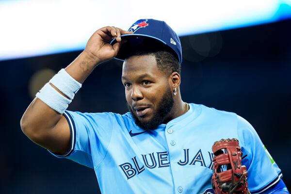 Toronto Blue Jays first baseman Vladimir Guerrero Jr. returns to the dugout following eighth-inning baseball game action against the Baltimore Orioles in Toronto, Sunday, March 30, 2025. (Christopher Katsarov/The Canadian Press via AP)