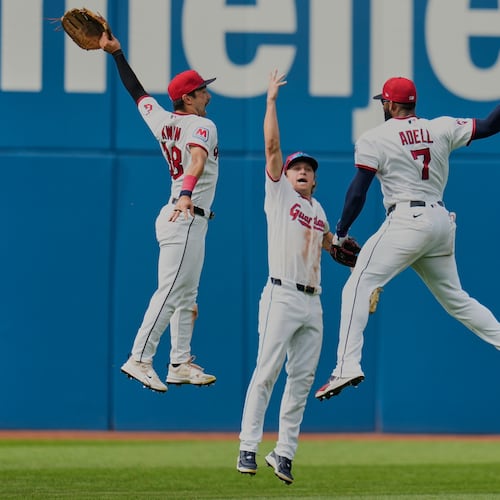 Cleveland Guardians left fielder Steven Kwan, left, center fielder Petey Halpin, center, and right fielder Jo Adell (7) celebrate after the Guardians defeated the Chicago White Sox in a baseball game in Cleveland, Wednesday, Sept. 16, 2026. (AP Photo/Sue Ogrocki)
