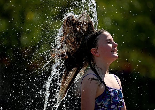 Kate Bayne, 10, plays in the Big Splash fountain at Town Center Park on Wednesday, Sept. 2, 2026, in Suwanee. In Atlanta, high temps are expected in the mid-90s on Friday, and the humidity will make the heat feel more oppressive. (Hyosub Shin/AJC)
