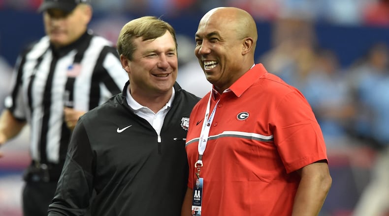 Georgia Bulldogs coach Kirby Smart  jokes with former Bulldog and NFL star Hines Ward before taking on the North Carolina Tar Heels in the Chick-fil-A Kickoff game at the Georgia Dome on Sept. 3, 2016. BRANT SANDERLIN/AJC file photo