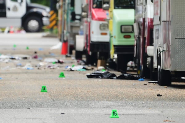 Evidence markers are seen the morning after a driver killed multiple people during a Filipino community festival, Sunday, April 27, 2025, in Vancouver, British Columbia. (AP Photo/Lindsey Wasson)
