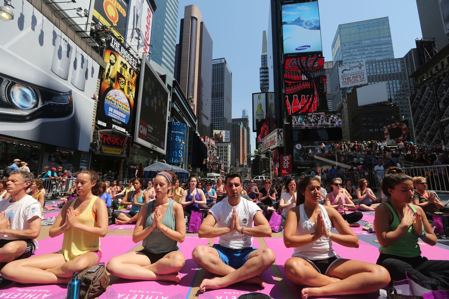 Enthusiasts perform yoga in Times Square to mark summer solstice, June 21, 2013