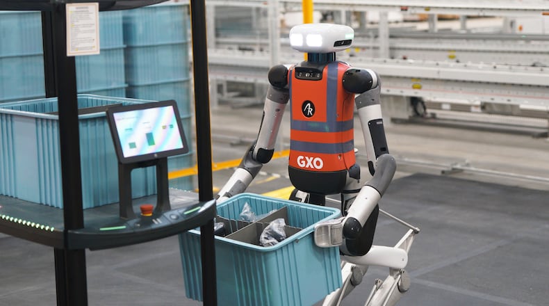 GXO's robot at work in the Spanx warehouse, moving a 'tote' box. The robot, which stands 5-feet-9-inches and weighs 140 pounds, is part of a pilot program to use robots for 'repetitive tasks,' the company said..