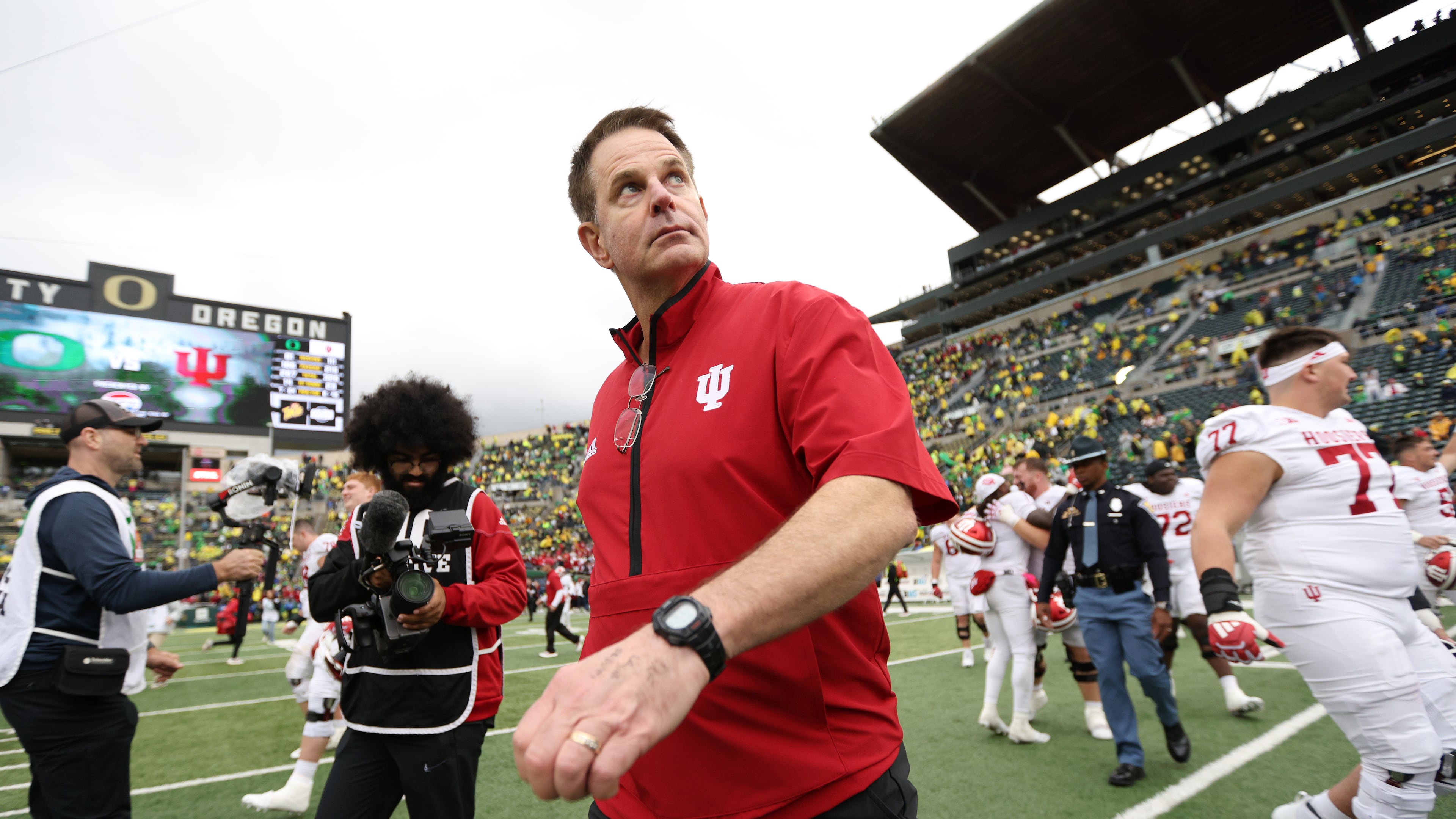 Indiana head coach Curt Cignetti, center, walks on the field after a win over Oregon in an NCAA college football game, Saturday, Oct. 11, 2025, in Eugene, Ore. (AP Photo/Lydia Ely)