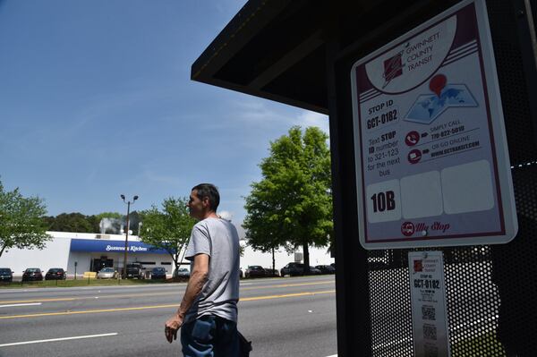 A customer waits for a Gwinnett County Transit at Buford Highway and N. Berkeley Lake Road on Wednesday, May 2, 2018. HYOSUB SHIN / HSHIN@AJC.COM