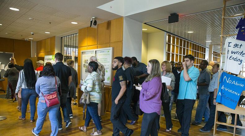 Individuals stream toward courtrooms during night court at the Gwinnett County Justice Center in Lawrenceville. Most of the cases scheduled for Thursday evenings involve large debt collection firms. (ALYSSA POINTER/ALYSSA.POINTER@AJC.COM)