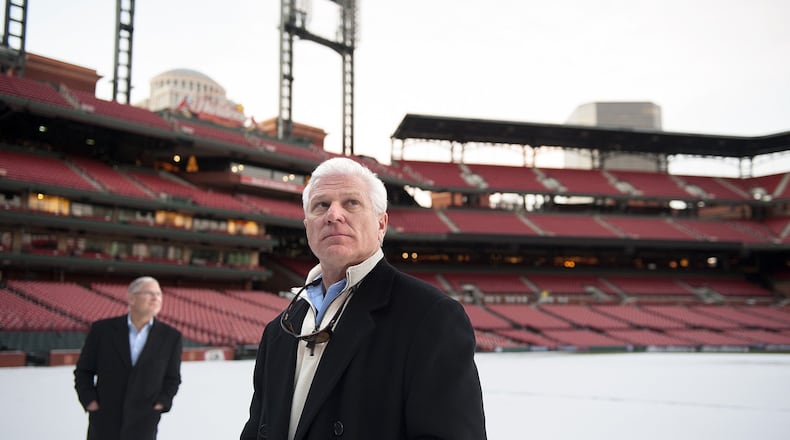 Atlanta Braves General Manager Frank Wren (right) and David Demarest of Jones Lang LaSalle (left) examine the snow-covered field and stands of Busch Stadium, home of the St. Louis Cardinals, during a tour of the stadium and adjoining Ballpark Village development Tuesday, Dec. 17, 2013. Photo by Sid Hastings.