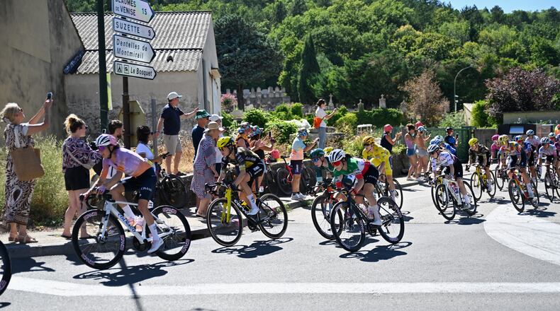 People watch the break away riders during the seventh stage of the Women's Tour de France cycling race (Tour de France Femmes) between La Voulte-sur-Rhone and Mont Ventoux in Malaucene, France, Friday, Aug. 7, 2026. (AP Photo/Philippe Magoni)