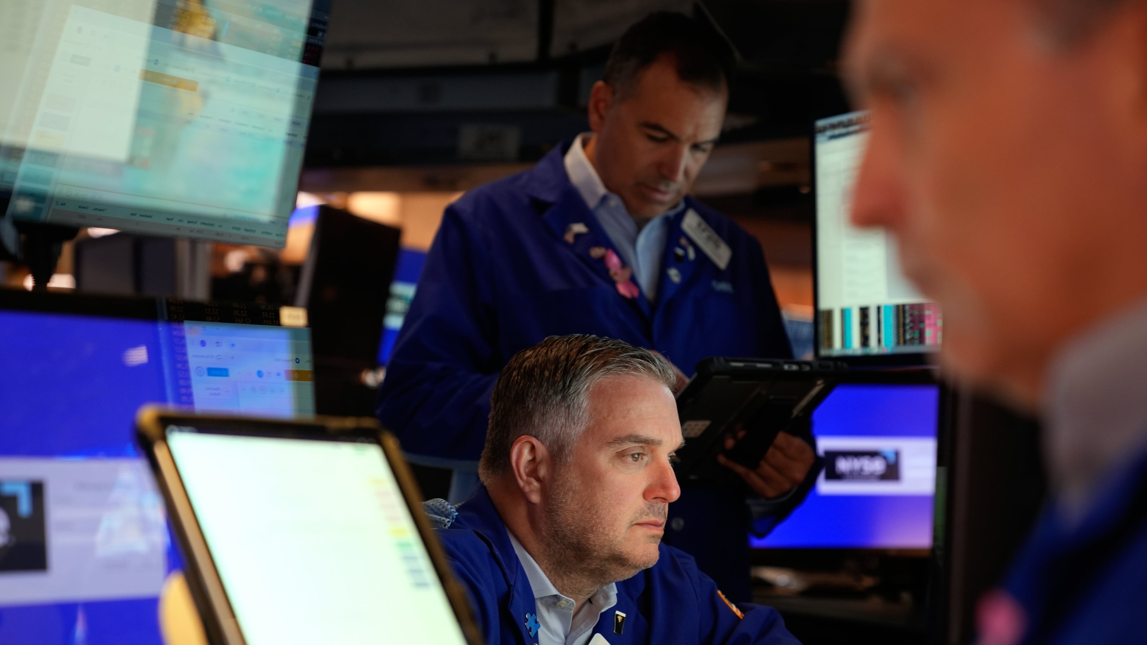 James Bodner, center, and others work on the floor at the New York Stock Exchange in New York, Wednesday, Oct. 1, 2025. (AP Photo/Seth Wenig)