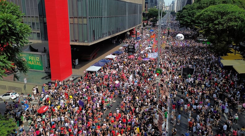 Demonstrators take parte in a march against femicide following a series of high-profile cases in the country, in Sao Paulo, Sunday, Dec. 7, 2025. (AP Photo/Ettore Chiereguini)