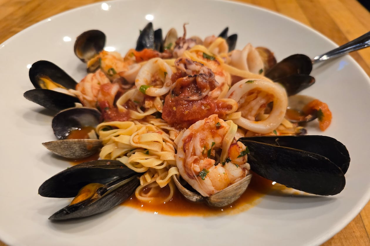A plate of seafood linguine with mussels, clams, shrimp and a light tomato sauce