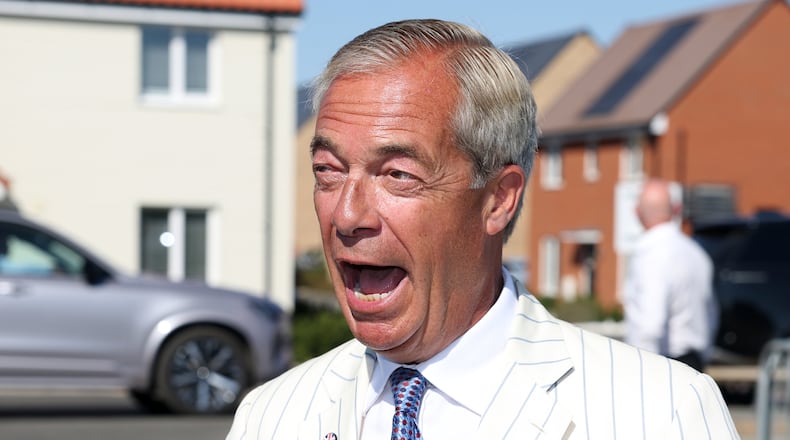 Britain's Reform UK party leader Nigel Farage arrives at a polling station in Walton on the Naze, Thursday, Aug. 13, 2026 to cast his vote for the Clacton on Sea by-election.(AP Photo/Richard Pelham)