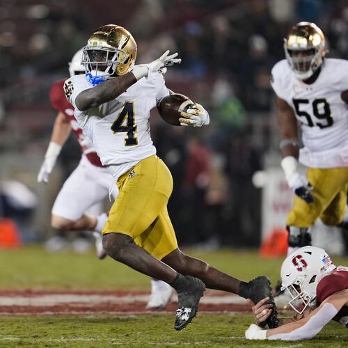 Notre Dame running back Jeremiyah Love (4) is tackled by Stanford safety Charlie Eckhardt (39) during the second half of an NCAA college football game, Saturday, Nov. 29, 2025, in Stanford, Calif. (AP Photo/Godofredo A. Vásquez)