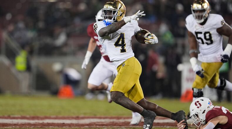 Notre Dame running back Jeremiyah Love (4) is tackled by Stanford safety Charlie Eckhardt (39) during the second half of an NCAA college football game, Saturday, Nov. 29, 2025, in Stanford, Calif. (AP Photo/Godofredo A. Vásquez)