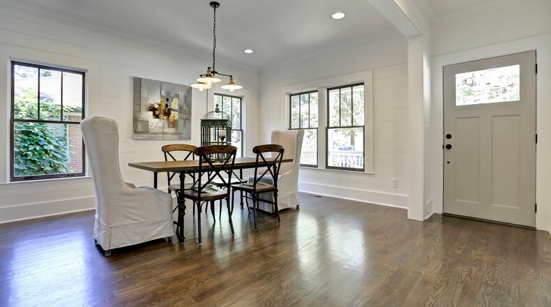 White shiplap, industrial lighting and warm wood floors create the perfect ambiance in this Ormewood Park renovation.
