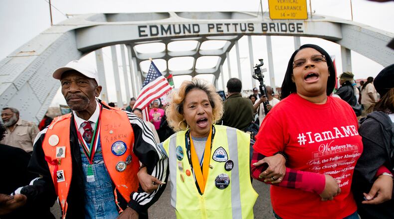 John Rankin, left, walks during the annual re-enactment of a key event in the civil rights movement in Selma, Ala., Sunday, March 5, 2017. Sunday marked the 52nd anniversary of the march across the Edmund Pettus Bridge over the Alabama River in Selma. On March 7, 1965, African-Americans seeking voting rights launched a march across the bridge en route to Montgomery but were attacked by police. That violent episode became known as "Bloody Sunday." (Albert Cesare/The Montgomery Advertiser via AP)