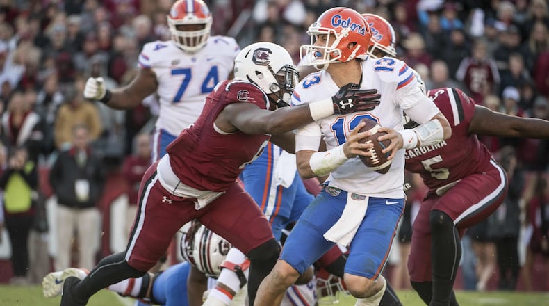 Florida quarterback Feleipe Franks attempts to elude South Carolina’s D.J. Wonnum during the Gators’ loss to the Gamecocks. (AP Photo/Sean Rayford)