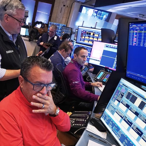 Trader Robert Finnerty Jr., foreground, works with colleagues on the floor of the New York Stock Exchange, Monday, Jan. 12, 2026. (AP Photo/Richard Drew)